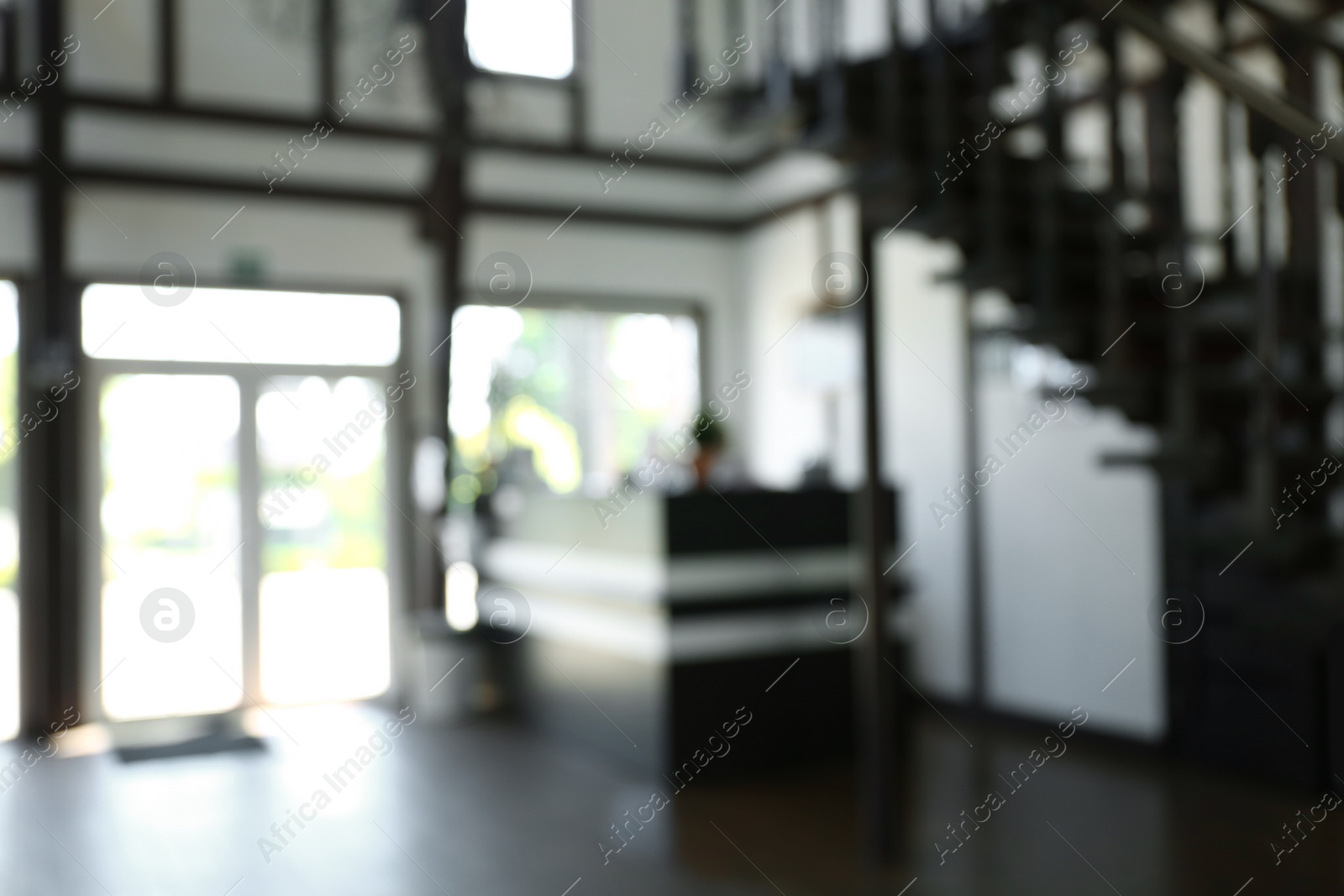 Photo of Blurred view of reception desk and stairs indoors