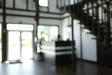 Blurred view of reception desk and stairs indoors