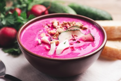 Delicious cold summer beet soup on table, closeup