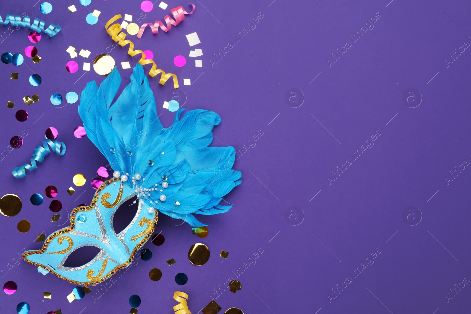 Photo of Flat lay composition with carnival items on purple background. Space for text