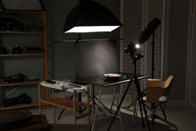 Photo of Professional equipment and salad with prosciutto on table in photo studio. Food photography