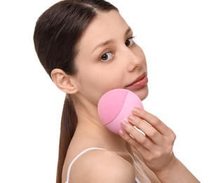 Photo of Washing face. Young woman with cleansing brush on white background