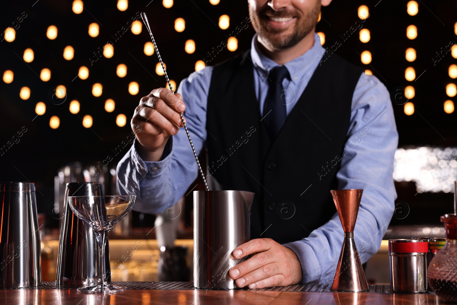 Photo of Bartender preparing fresh alcoholic cocktail in bar, closeup