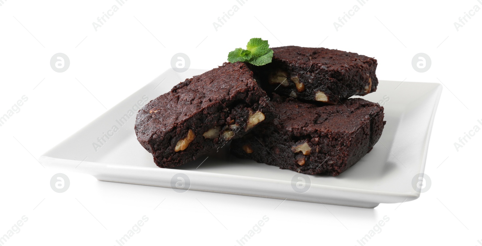 Photo of Delicious brownies with nuts and mint on white background