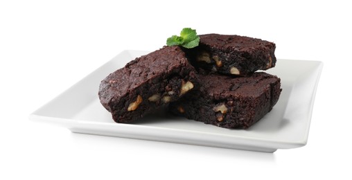 Delicious brownies with nuts and mint on white background