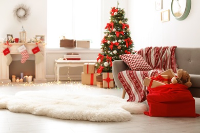 Room interior with Christmas tree and Santa's bag of gifts