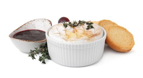 Photo of Tasty baked camembert, croutons and jam isolated on white