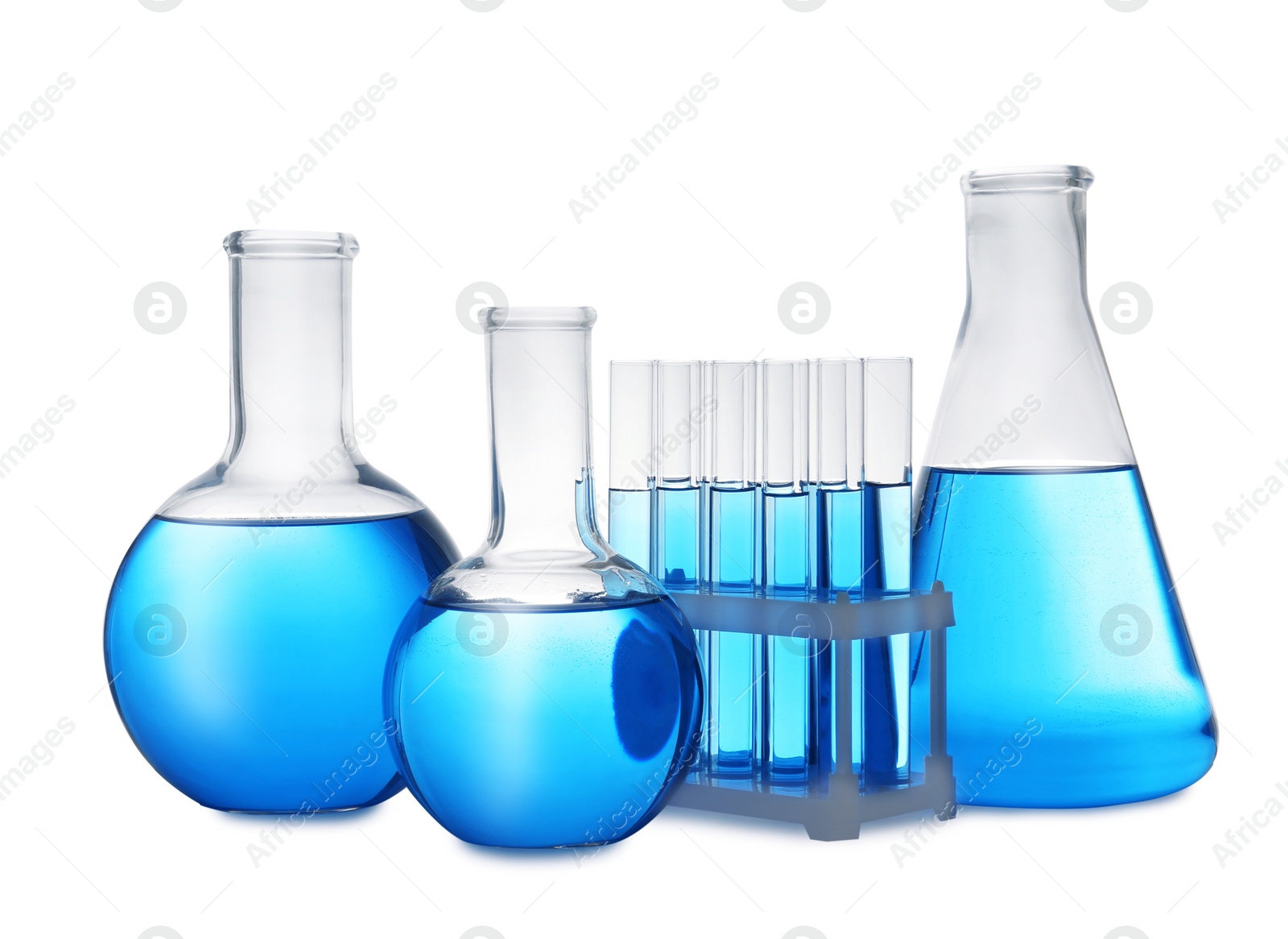 Photo of Set of laboratory glassware with blue liquid on white background