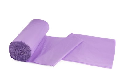 Photo of Roll of violet garbage bags on white background. Cleaning supplies