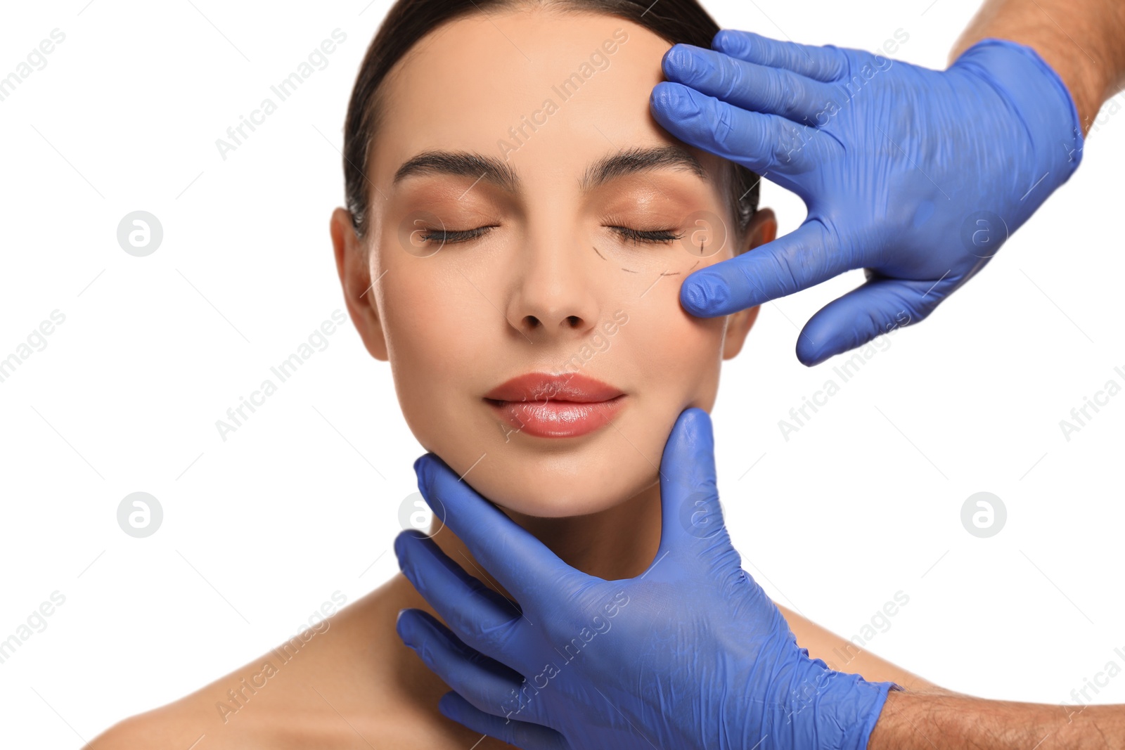 Photo of Doctor checking patient's face before cosmetic surgery operation on white background, closeup