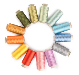 Photo of Frame of colorful sewing threads on white background, top view. Space for text