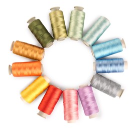 Frame of colorful sewing threads on white background, top view. Space for text