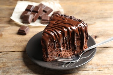 Photo of Tasty chocolate cake served on wooden table