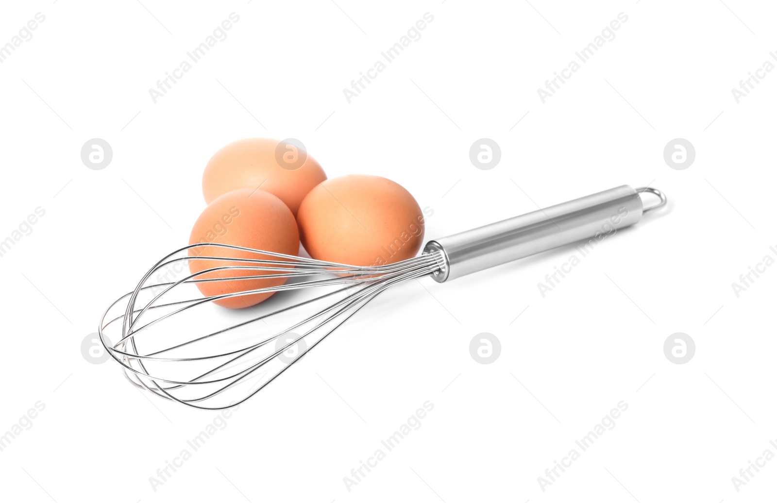 Photo of Metal whisk and raw eggs isolated on white