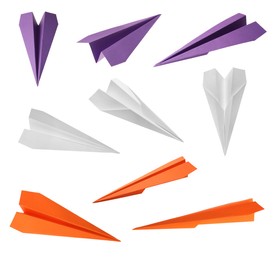 Image of Set with handmade different color paper planes on white background