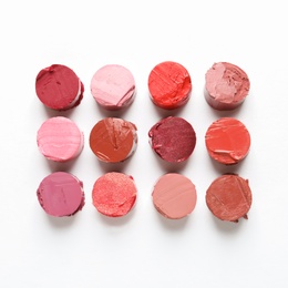 Different lipstick swatches on white background, top view