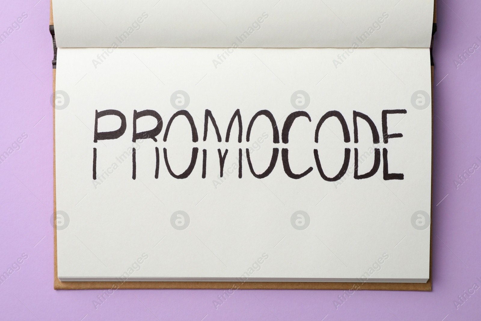 Photo of Notebook with words Promo Code on violet background, top view