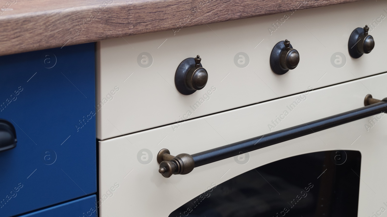 Photo of New stylish oven in kitchen, closeup. Cooking appliance