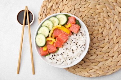 Delicious poke bowl with salmon, rice and vegetables on white table, flat lay