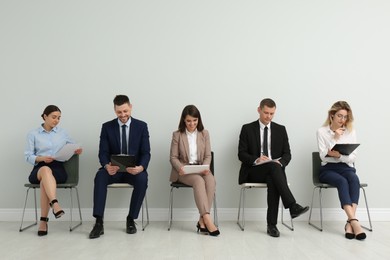 Photo of People waiting for job interview in office hall