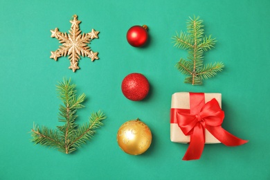 Flat lay Christmas composition with gift box and festive decor on color background