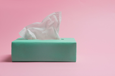 Photo of Box with paper tissues on pink background