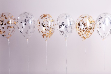 Color balloons with ribbons on white background