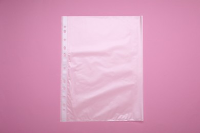 Photo of Punched pocket on pink background, top view