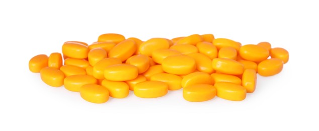Photo of Tasty orange dragee candies on white background