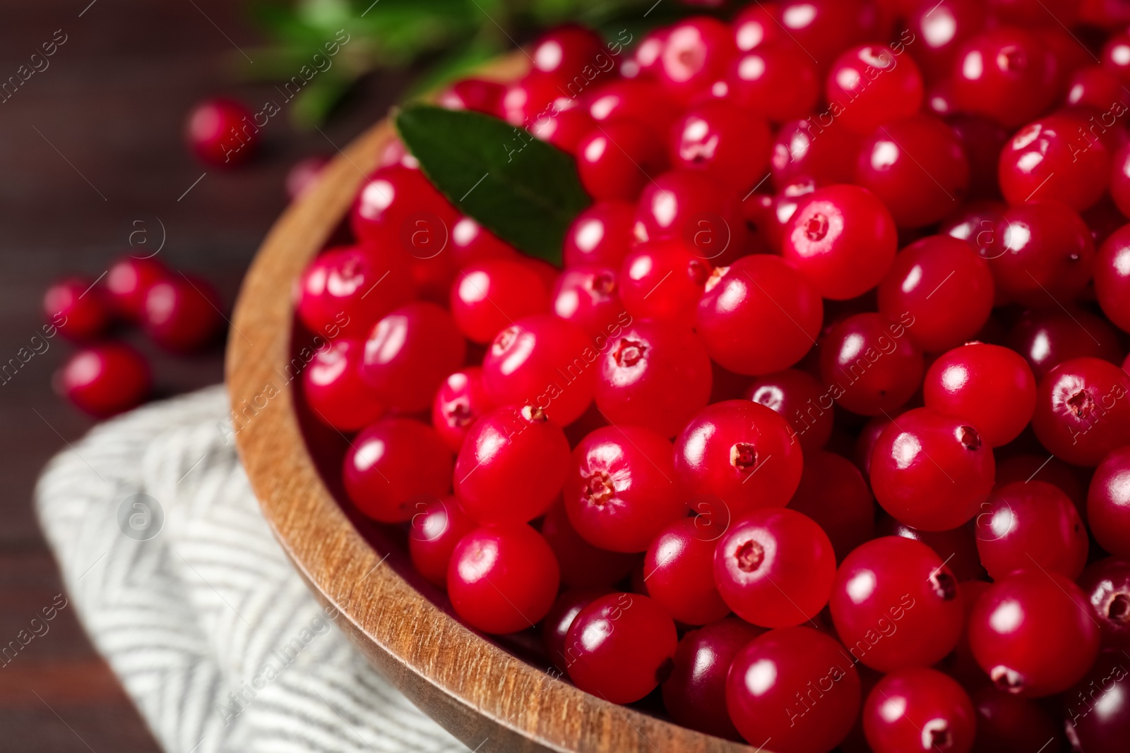 Photo of Plate with tasty ripe cranberries on table, closeup