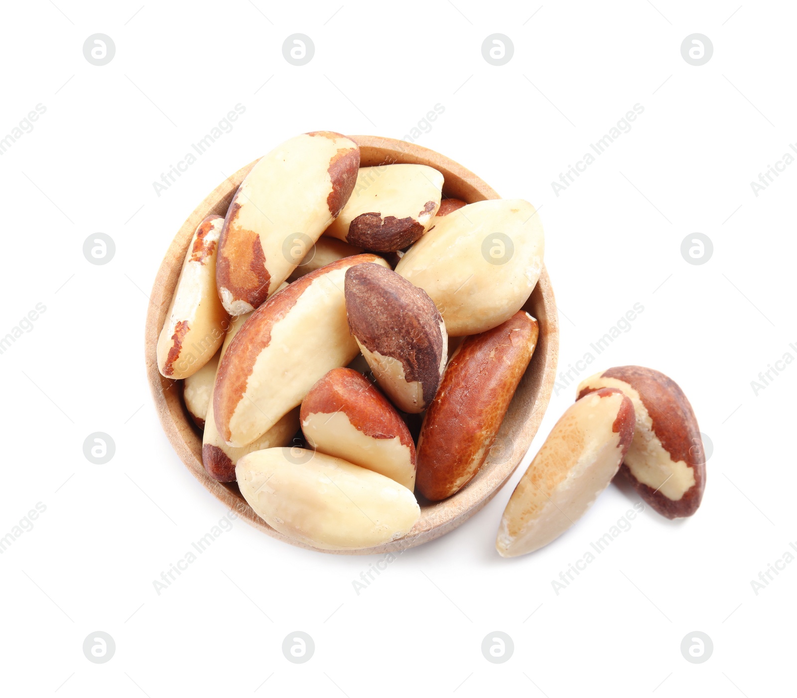 Photo of Wooden bowl with Brazil nuts on white background, top view