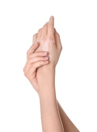 Young woman applying cream onto her hands on white background, closeup