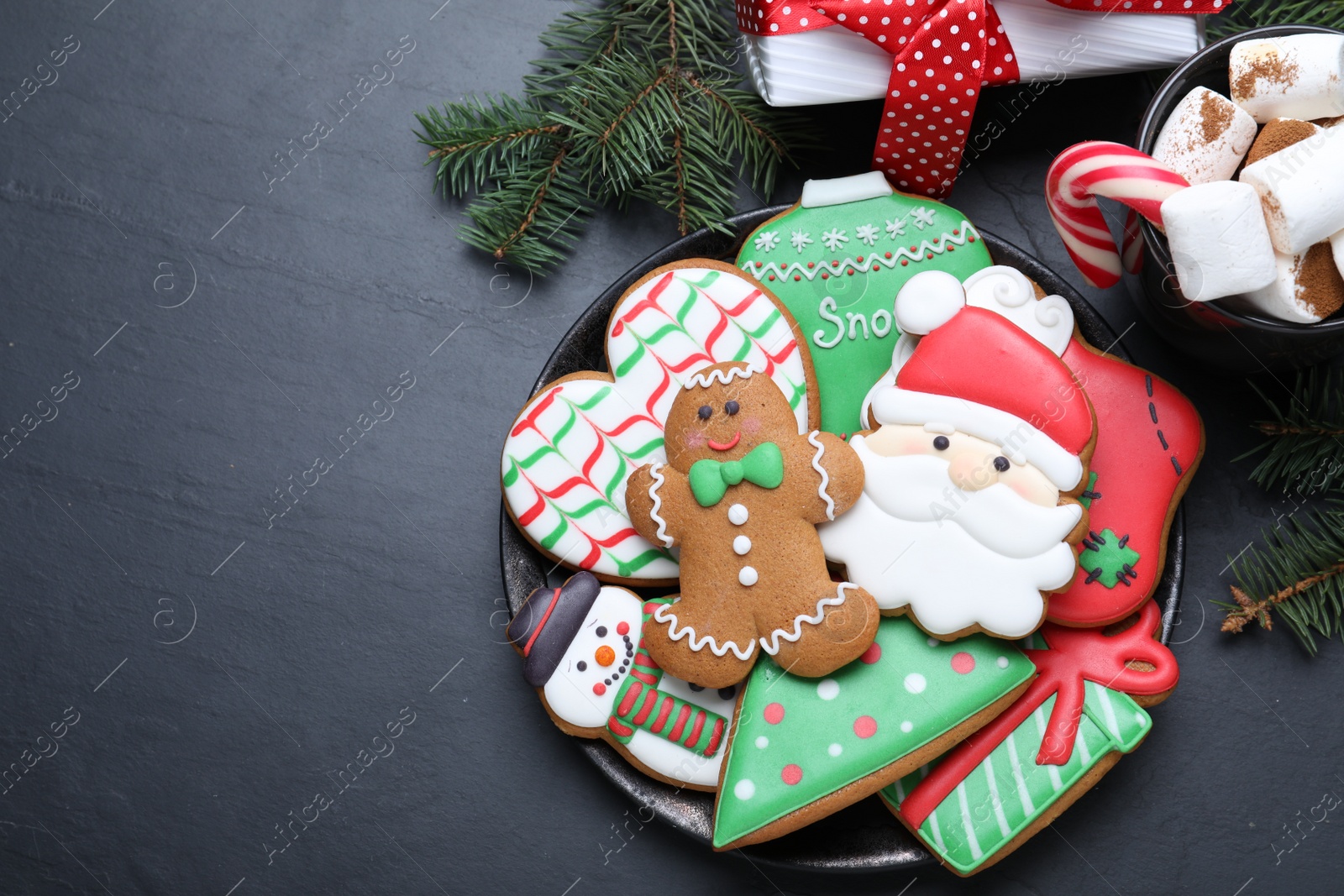 Photo of Delicious gingerbread Christmas cookies on black table, flat lay. Space for text