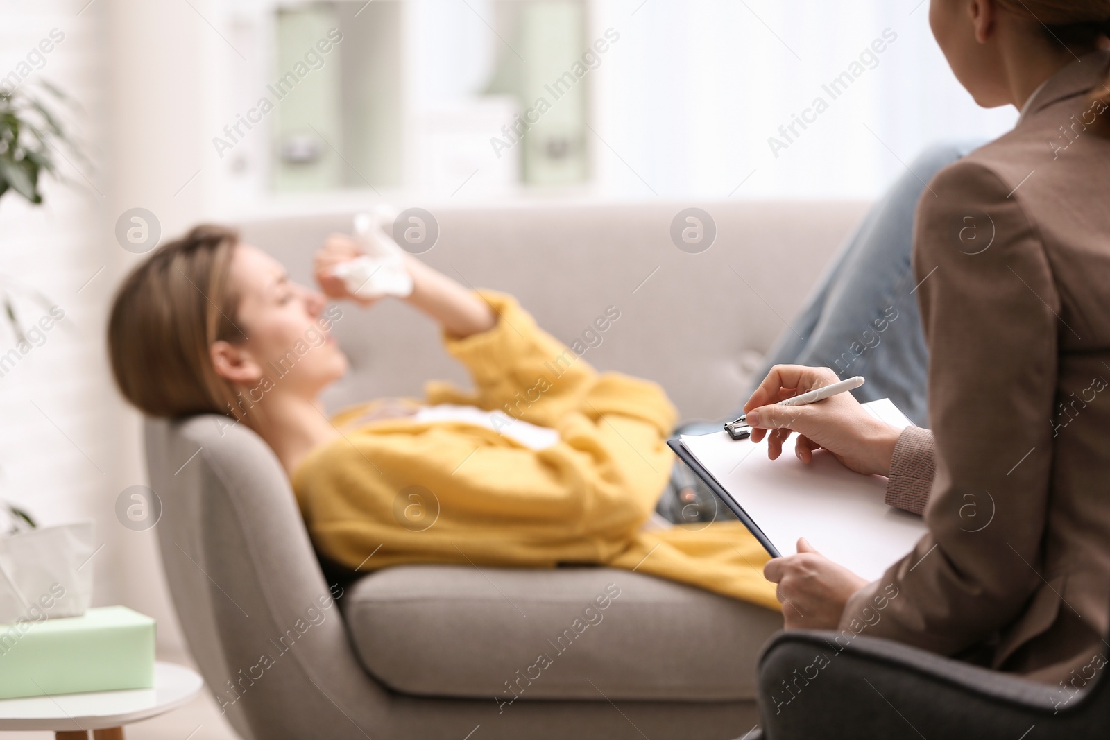 Photo of Psychotherapist working with woman in office, closeup