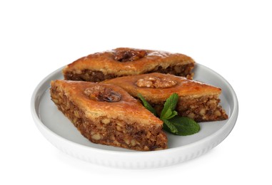 Photo of Plate of delicious honey baklava with walnuts on white background