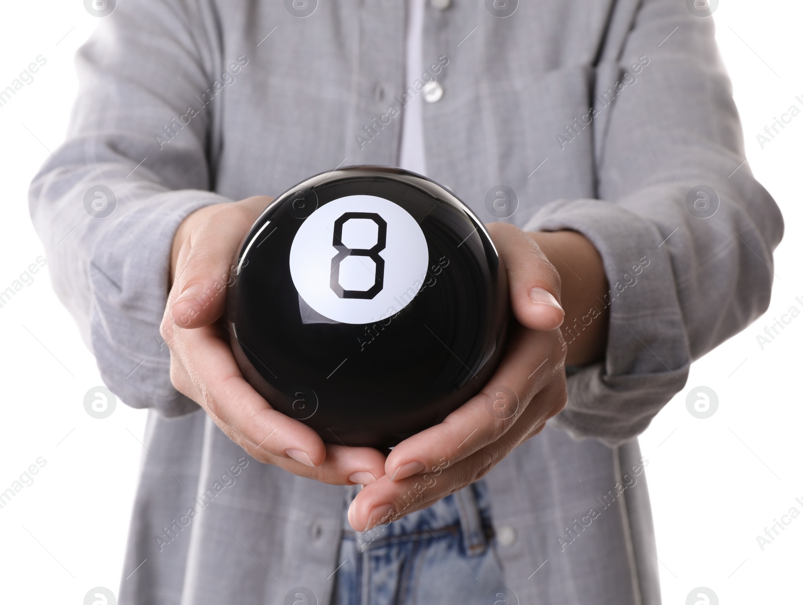 Photo of Woman holding magic eight ball on white background, closeup