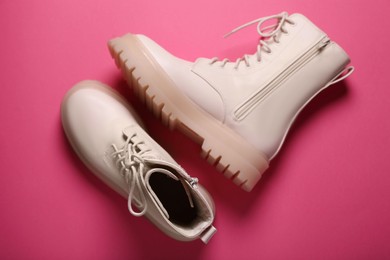 Pair of stylish leather shoes on pink background, flat lay