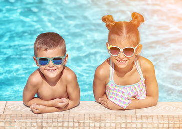 Happy cute little children in swimming pool