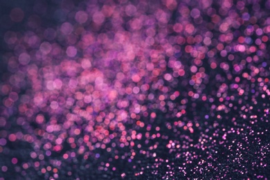 Pink glitter with bokeh effect on dark background