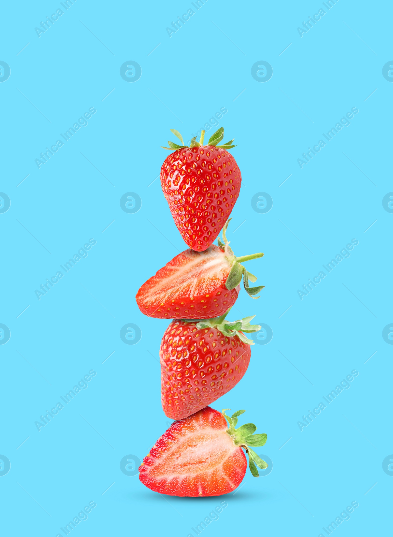 Image of Stack of fresh strawberries on light blue background