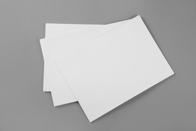 Photo of Blank brochures on grey background, top view. Mockup for design