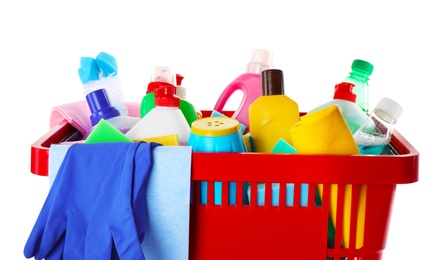 Shopping basket with different detergents, rag and gloves on white background