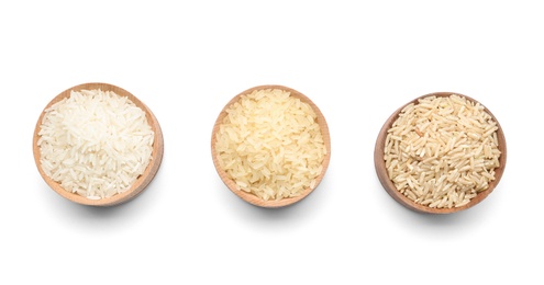 Photo of Bowls with different types of uncooked rice on white background, top view