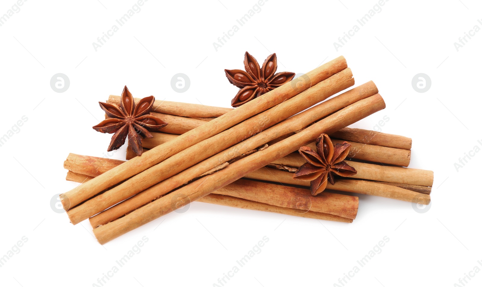 Photo of Aromatic cinnamon sticks and anise isolated on white, top view