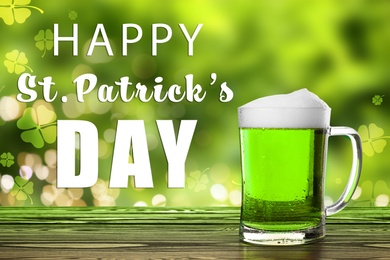 Image of Happy St. Patrick's Day. Tasty green beer on wooden table