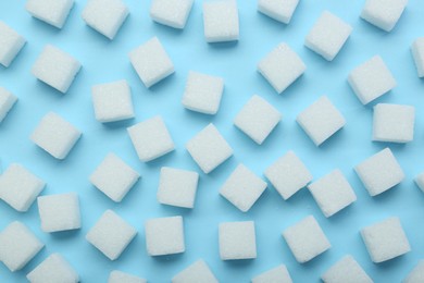 White sugar cubes on light blue background, top view