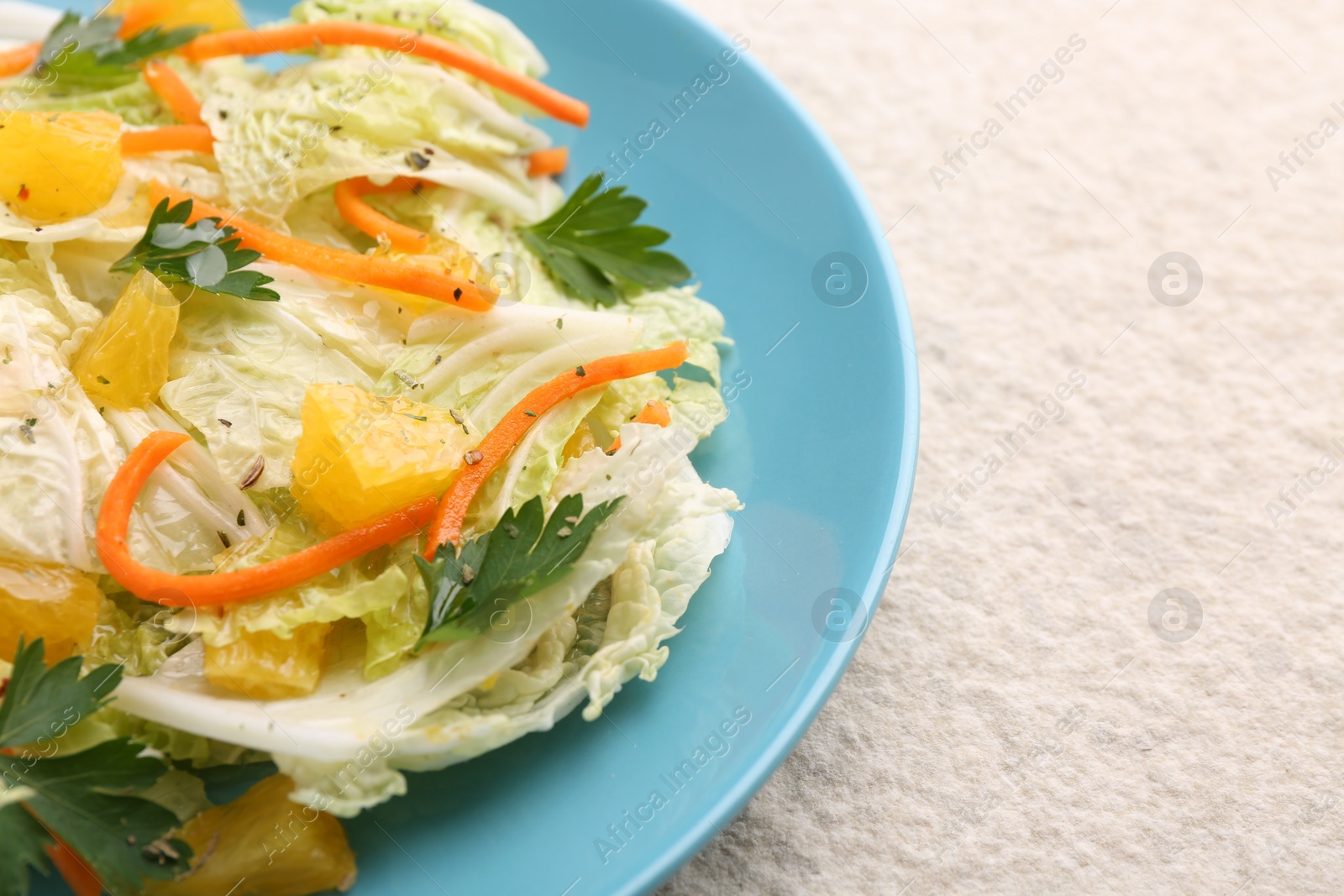 Photo of Tasty salad with Chinese cabbage on beige textured table, closeup. Space for text