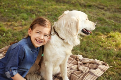 Photo of Cute little child with his pet in green park