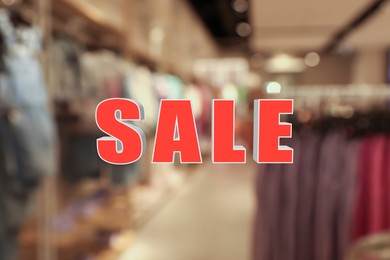 Image of Word Sale and blurred view of fashion store with clothes