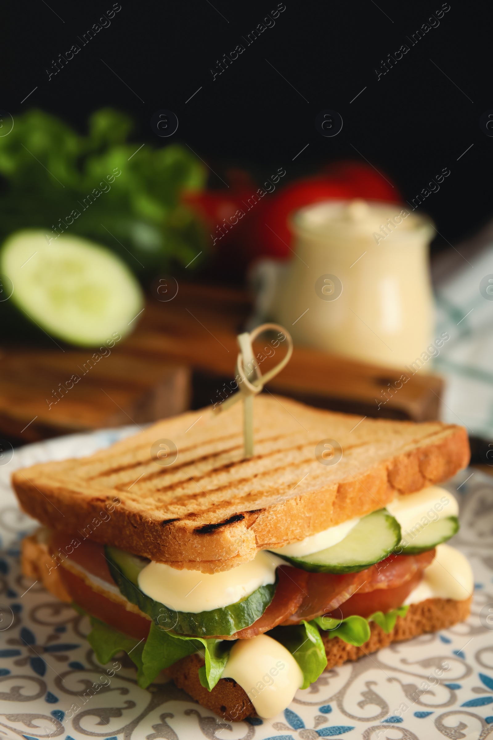 Photo of Delicious sandwich with vegetables, ham and mayonnaise on plate, closeup